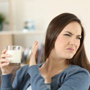 Woman refusing a glass of milk