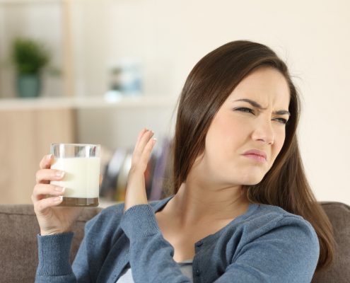 Woman refusing a glass of milk